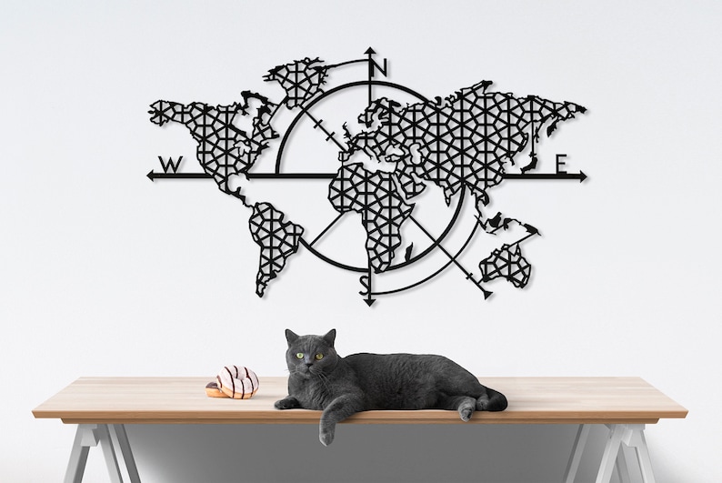 May include: Black metal world map wall art with a compass design. The map is detailed and includes all continents. The compass has the letters N, S, E, and W.