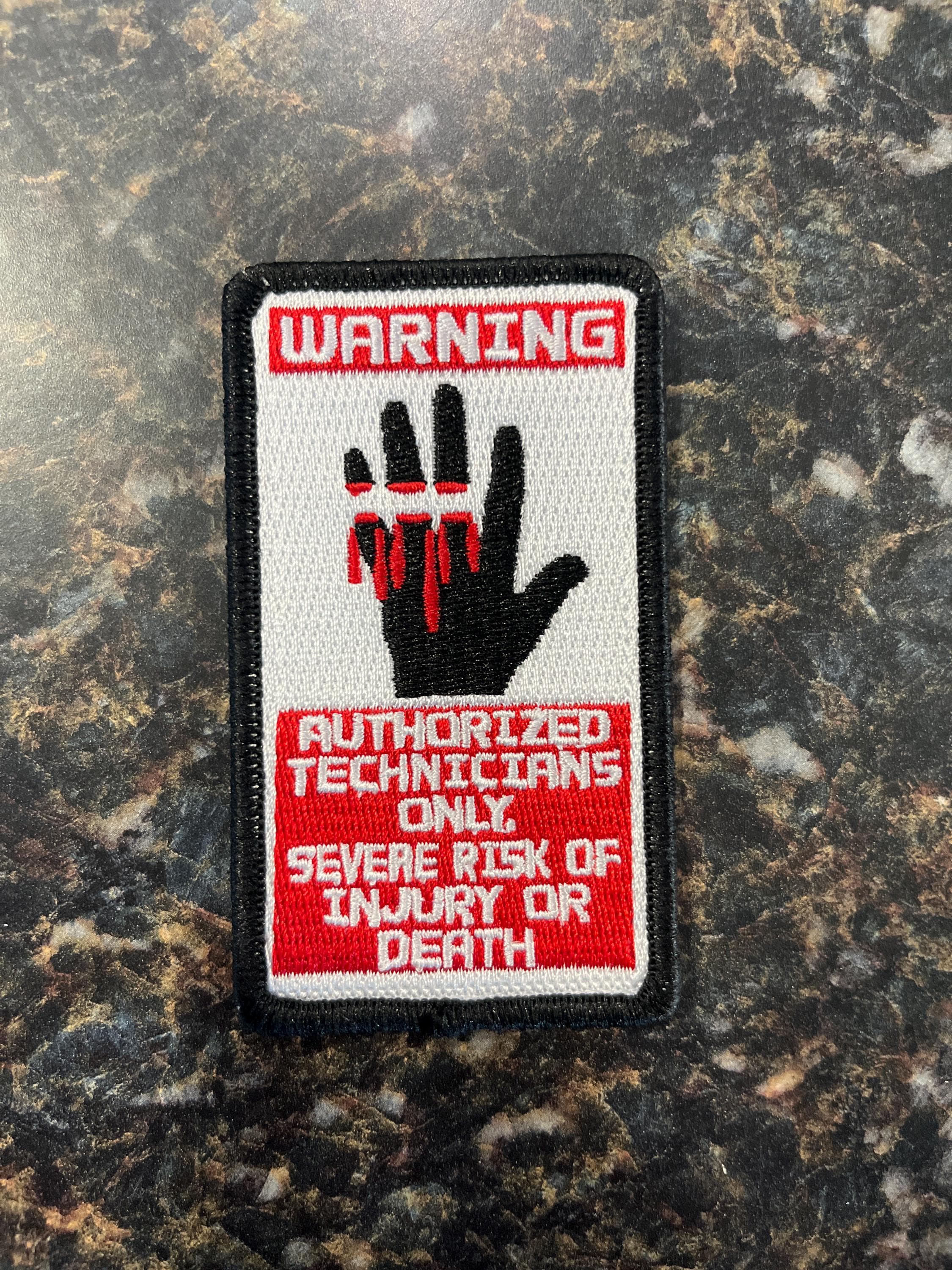 Dead Space: Warning - Authorized Technicians Only. Severe Risk of Injury or Death Patch. 2 inches wide by 3.5 inches tall.