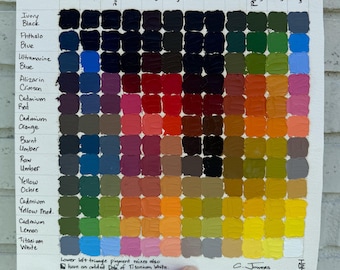 May include: A square color mixing chart on paper featuring a grid of oil paint swatches. The grid displays various pigment combinations labeled with names like Ivory Black, Phthalo Blue, and Titanium White. Text at the bottom explains the lower left triangle includes added Titanium White.