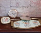 Victorian petite point vanity set, Beautiful Brass handled brush large hand mirror, brass tray with needle point inset, and table clock.