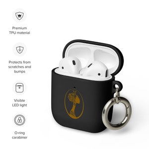 May include: Black silicone case for AirPods with a gold design of a woman's profile. The case has a built-in carabiner.