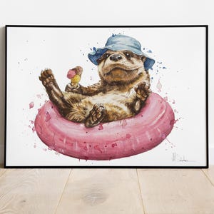 Peut inclure: Une peinture à l'aquarelle d'une loutre brune portant un chapeau bleu et tenant un cornet de glace. La loutre flotte dans une bouée gonflable rose sur un fond blanc.