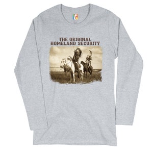 May include: A gray long-sleeve t-shirt with the text "THE ORIGINAL HOMELAND SECURITY" and a vintage image of two Native American men on horseback.