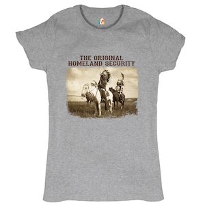 May include: A grey t-shirt with the text "THE ORIGINAL HOMELAND SECURITY" and a vintage image of two Native American men on horseback.