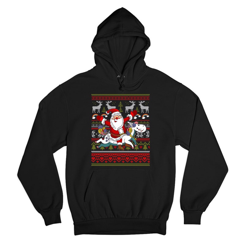 May include: Black hooded sweatshirt with a Christmas-themed design featuring Santa Claus riding a unicorn. The design includes a red and green color scheme with snowflakes, reindeer, and a Christmas tree.