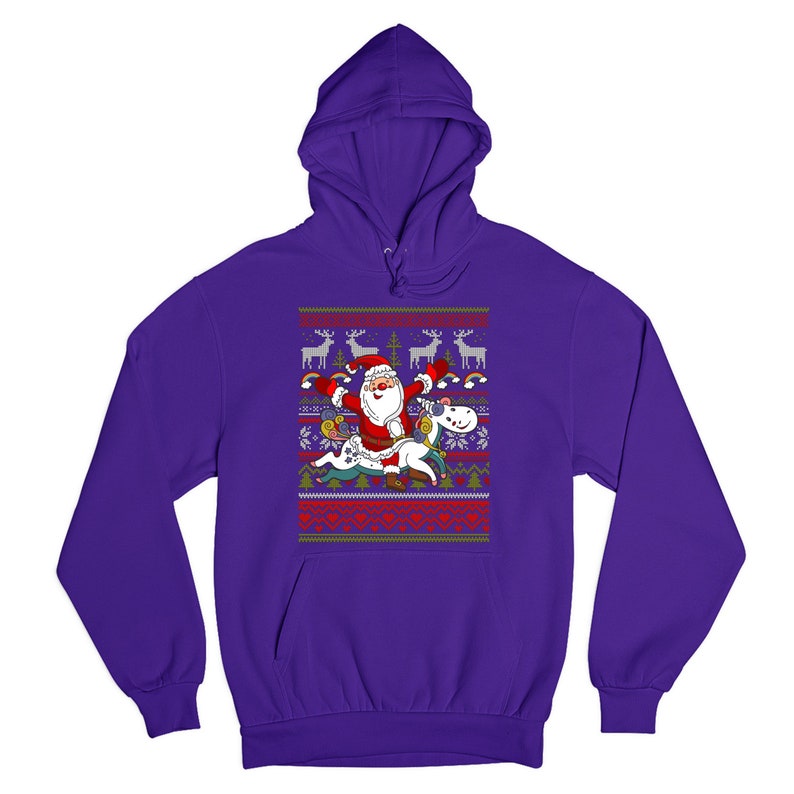 May include: Purple hooded sweatshirt with a Christmas-themed design featuring Santa Claus riding a unicorn. The design includes reindeer, snowflakes, and rainbows.