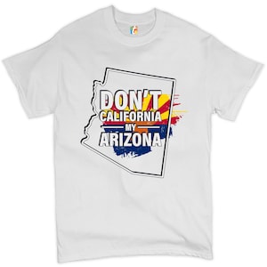 May include: White t-shirt featuring a graphic of the Arizona state outline. The graphic is in black and includes the text "Don't California My Arizona" with a red, yellow, and blue colour scheme.
