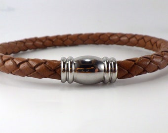May include: A brown leather bracelet with a stainless steel magnetic clasp.