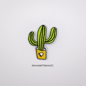 May include: Green embroidered cactus patch with a yellow pot and a white heart. The patch is 45mm wide and 50mm tall.