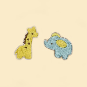 May include: Two embroidered iron-on patches, one of a yellow giraffe and one of a blue elephant.