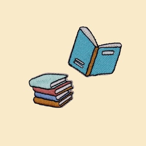 May include: Embroidered patches featuring stacks of books and an open book. The books have blue, red, and brown covers. The open book is blue with a brown spine. The patches are on a cream-colored background.