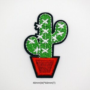May include: Green embroidered cactus with white accents in a red pot. The cactus is 40mm wide and 60mm tall.