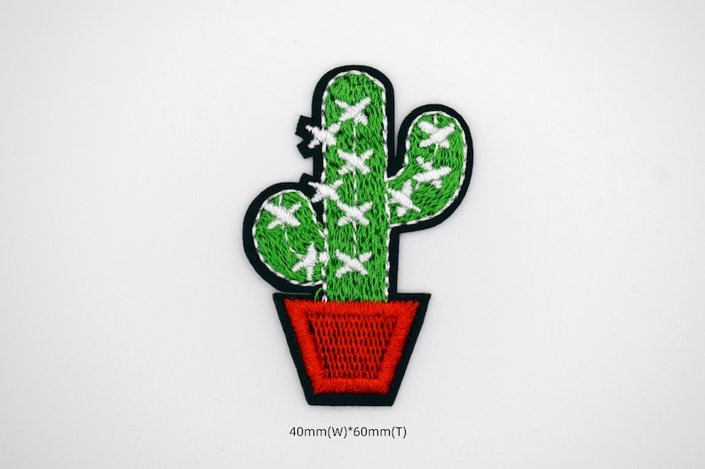 May include: Green embroidered cactus with white accents in a red pot. The cactus is 40mm wide and 60mm tall.