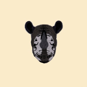 May include: Embroidered iron-on patch featuring a black and gray rhinoceros head.