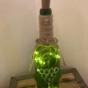 decorative light up wine bottle with glass grapes