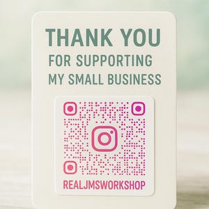 May include: A rectangular off-white card featuring the dark green text THANK YOU FOR SUPPORTING MY SMALL BUSINESS. Below the text is a square pink QR code with a central Instagram icon and the pink text REALJMSWORKSHOP printed underneath it.