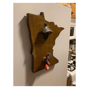 Minnesota shaped bottle opener with hidden magnetic cap catcher