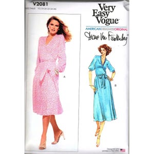 May include: A vintage sewing pattern from Very Easy Vogue featuring two wrap dress designs. The pattern includes a pink, long-sleeved dress and a blue, short-sleeved dress. The designer is Diane Von Furstenberg. The pattern size is Y5 (18-20-22-24-26).