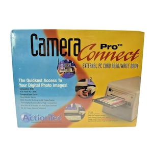 May include: A rectangular product box for the ActionTec Camera Connect Pro external PC card read/write drive. The packaging features blue and yellow gradients, product imagery, and text detailing compatibility with ATA Flash, CompactFlash, and SmartMedia cards.