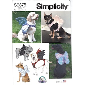 May include: Simplicity S9875 sewing pattern for dog costumes featuring various wing designs. The pattern includes illustrations and photographs of dogs wearing harnesses with attached wings in styles like bat, butterfly, and fairy, in sizes S-L.