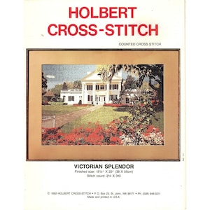 May include: A Holbert Cross-Stitch pattern titled Victorian Splendor, featuring a white house with columns, a lawn, and red flowers. The finished size is 15.5 inches by 22 inches, with a stitch count of 214 by 310. The design is printed on paper.