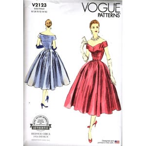 May include: A white ceramic mug with a black handle and the text "But First, Coffee" in a black, bold font. The mug is on a white surface.