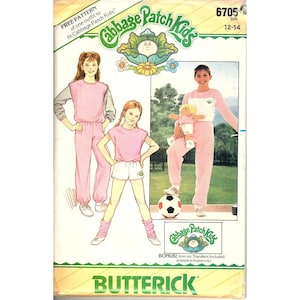 May include: A vintage Butterick sewing pattern featuring Cabbage Patch Kids. The cover shows illustrations of girls in pink and white athletic outfits. The pattern includes a free pattern for one outfit and is sized for 12-14.