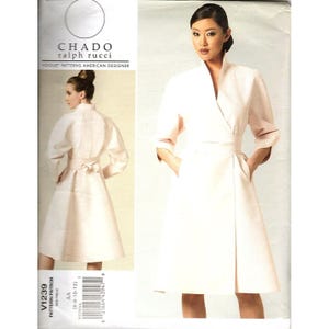 Pode incluir: Um padrão Vogue para um vestido envelope rosa claro com cinto e bolsos a condizer, e um casaco a condizer. O padrão é de Ralph Rucci para Chado. O número do padrão é V1239. Medidas em cm.