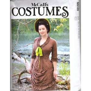 May include: McCall's M8189 sewing pattern envelope featuring a brown dress with a small white dot pattern, a ruffled neckline, three-quarter sleeves, a lime green bow, and a front button closure. The skirt has a gathered, draped design.