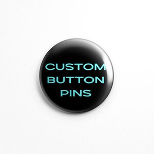 May include: A black button pin with the text "CUSTOM BUTTON PINS" in light blue.