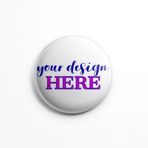 May include: White round button with the text "your design HERE" in blue and pink lettering.