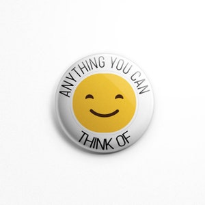 May include: A circular pin-back button with a white background and a central yellow smiley face icon. The text "ANYTHING YOU CAN" is printed in black along the top curve, and the text "THINK OF" is printed in black along the bottom curve.