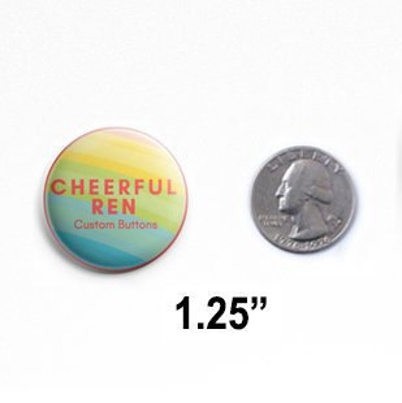 May include: A round pin-back button with a rainbow-colored background featuring the text CHEERFUL REN Custom Buttons in orange and white. The button is shown next to a US quarter for scale, with the text 1.25 inches indicating its diameter.