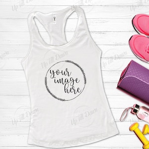 May include: White tank top with a black circle and the text "your image here" inside. The tank top is on a white wooden surface with a purple yoga mat, pink sneakers, and yellow dumbbells.