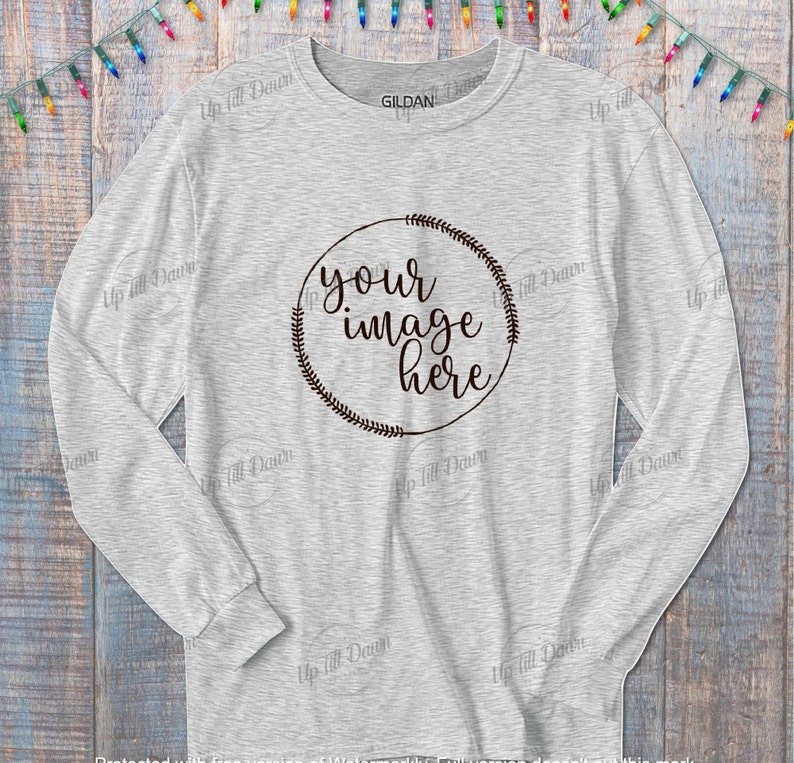 K&ouml;nnte beinhalten: Ein hellgraues Langarmshirt mit einem runden Kranzdesign, auf dem in schwarzer Schrift "your image here" steht.