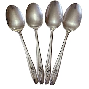 May include: A set of three ceramic mugs with a speckled, matte finish. The mugs are in shades of cream, light gray, and dark gray. Each mug has a simple, minimalist design and a rounded handle.