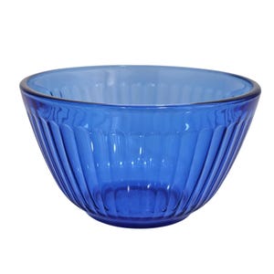May include: A vibrant blue glass bowl with a ribbed exterior. The bowl has a wide, open top and a rounded base. The glass is transparent, allowing light to pass through. This bowl is suitable for serving salads, snacks, or as a decorative piece.