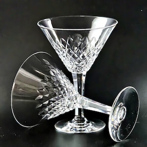 May include: Two clear glass martini glasses with a diamond pattern. The glasses are stacked on top of each other.