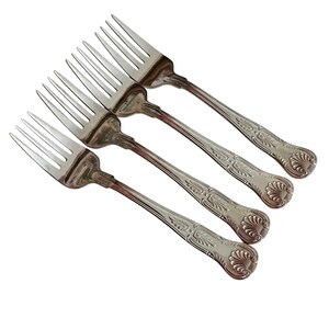 May include: Four silver forks with ornate, floral-patterned handles. The tines are long and slender, and the forks are arranged diagonally against a white background. The silverware appears to be vintage or antique.