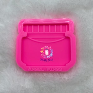 Pode incluir: Forma de silicone rosa em forma de frasco de vidro com o texto "Angel Wings" e as palavras "Huffy Girl" em uma coroa de borboletas.