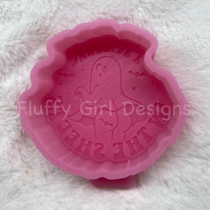 May include: Pink silicone mold with a ghost design and the text "She's the  " in a white font.