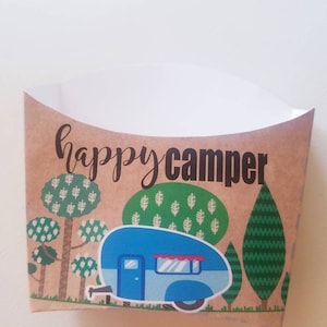 May include: A brown paper food container with a blue camper van illustration and the text "happy camper". The camper van is surrounded by green trees.