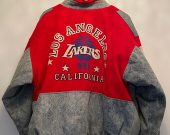 May include: A red and blue Los Angeles Lakers jacket with a denim bottom. The jacket has the team logo and "Los Angeles Lakers NBA California" written on the back.