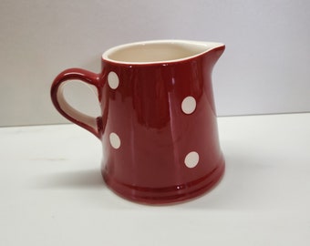 Lovely polka-dot red creamer milk jug with cream interior and cream spots