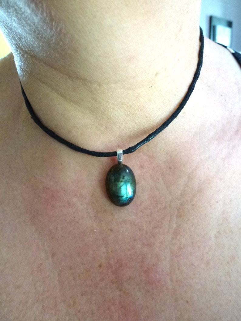 oval cabochon in real blue Labradorite mounted in pendant on black waxed cotton cord musket closure and extension chain