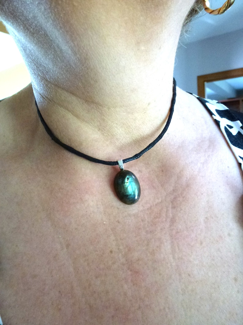 oval cabochon in real blue Labradorite mounted in pendant on black waxed cotton cord musket closure and extension chain