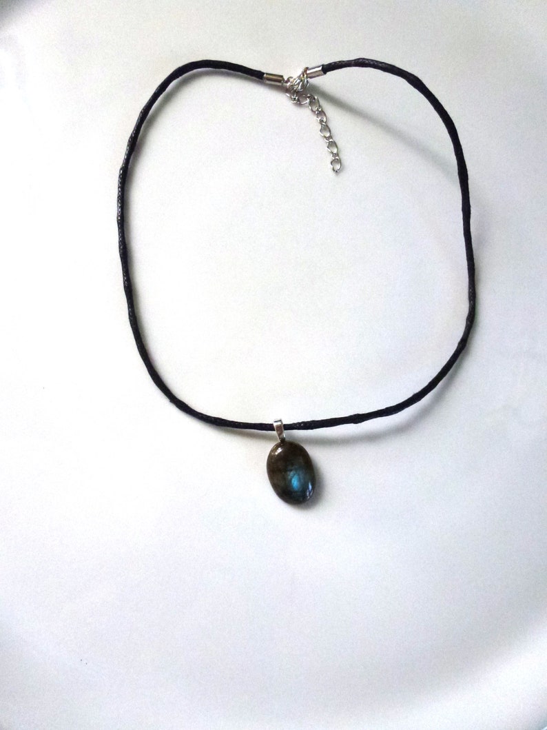 oval cabochon in real blue Labradorite mounted in pendant on black waxed cotton cord musket closure and extension chain