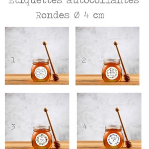 May include: Four round honey jars with labels featuring floral wreaths and personalised text. The jars are 4 cm in diameter and come with wooden honey dippers. The labels are white with black text and green and red floral designs.