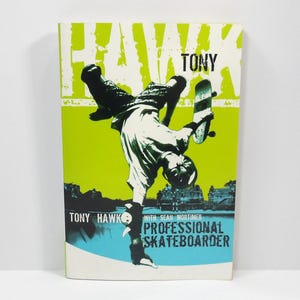 May include: A book cover featuring a skateboarder in mid-air, performing a trick. The cover has a lime green and blue background with the name "TONY HAWK" in large white letters. The text "PROFESSIONAL SKATEBOARDER" is also visible.