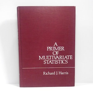 May include: A maroon book titled "A Primer of Multivariate Statistics" by Richard J. Harris. The title and author's name are in white font. The book has a simple, clean design.